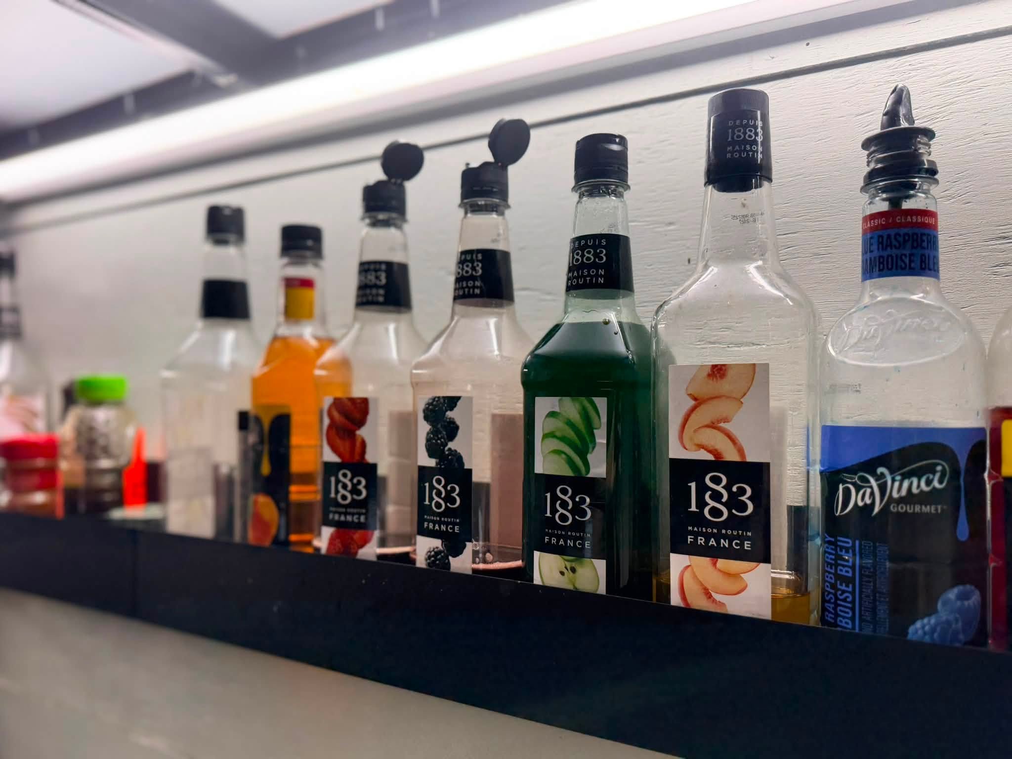 A shelf of flavored syrups