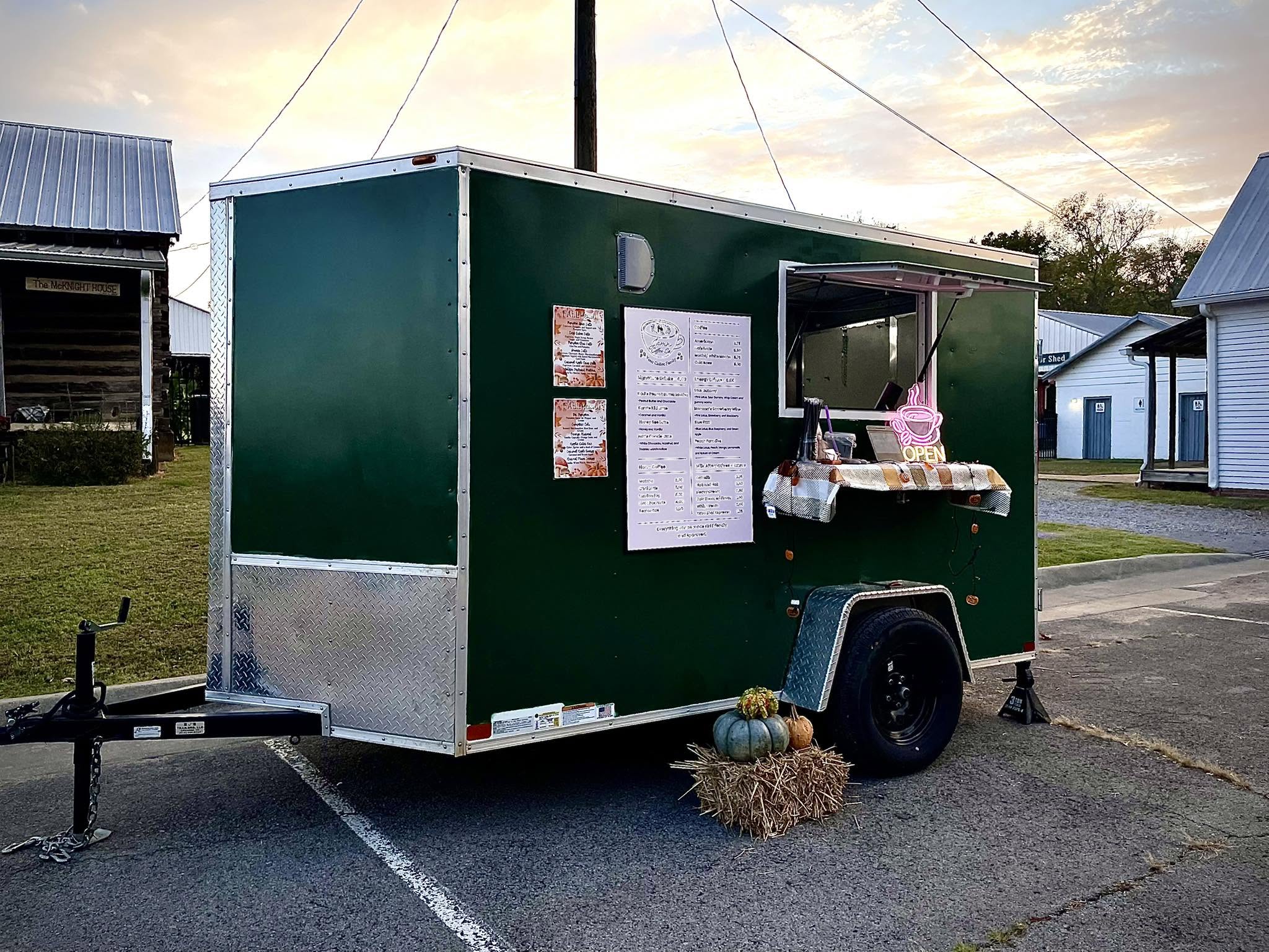 The green Jamn Coffee Co. trailer with its menu board and open sign